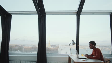 african american businessman talking on video call in rooftop office