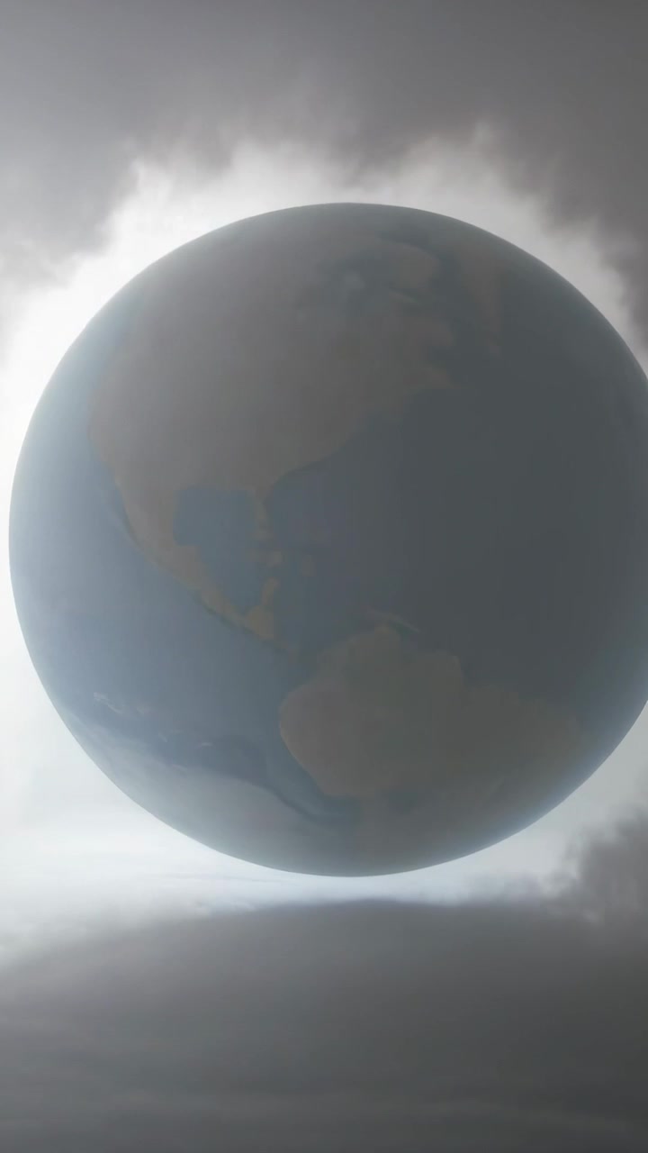 Wideo pionowe: Sekwencja klatek przedstawiająca ciemną planetę obracającą się lekko, dryfującą nad aureolą chmur.