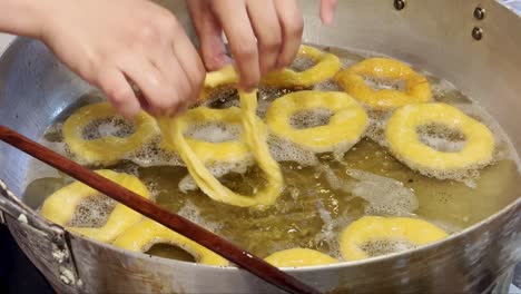 peruvian cook making picarones, a typical sweet treat in per?