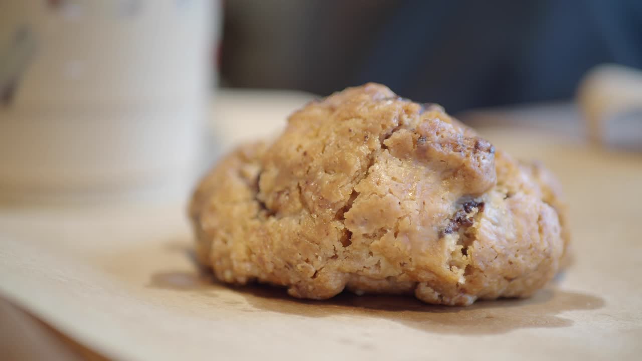 Hand Picking Up a Delicious Cookie from Parchment Paper