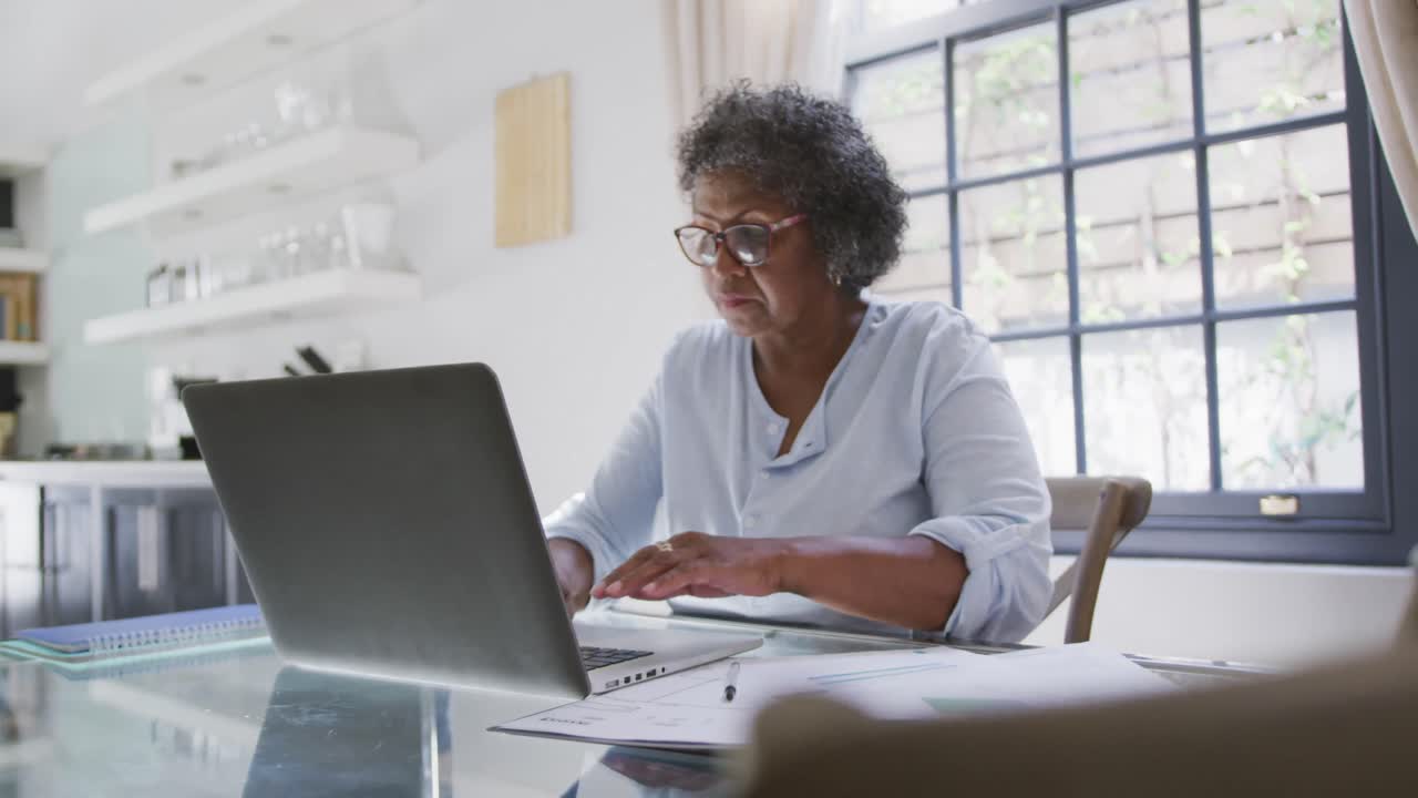 Senior mixed race woman using a laptop. Social distancing and self isolation in quarantine