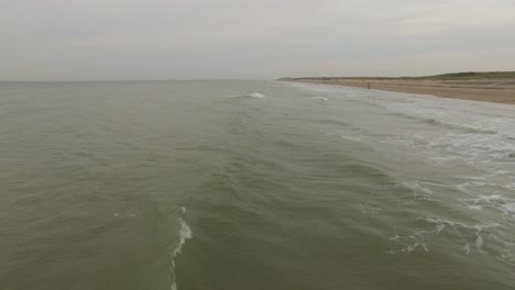 Aerial:-An-overcast-day-at-the-sand-beach-between-Domburg-and-Westkapelle,-the-Netherlands