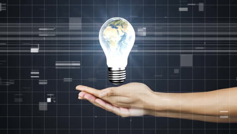 holding glowing light bulb with earth, hand over digital animation grid background