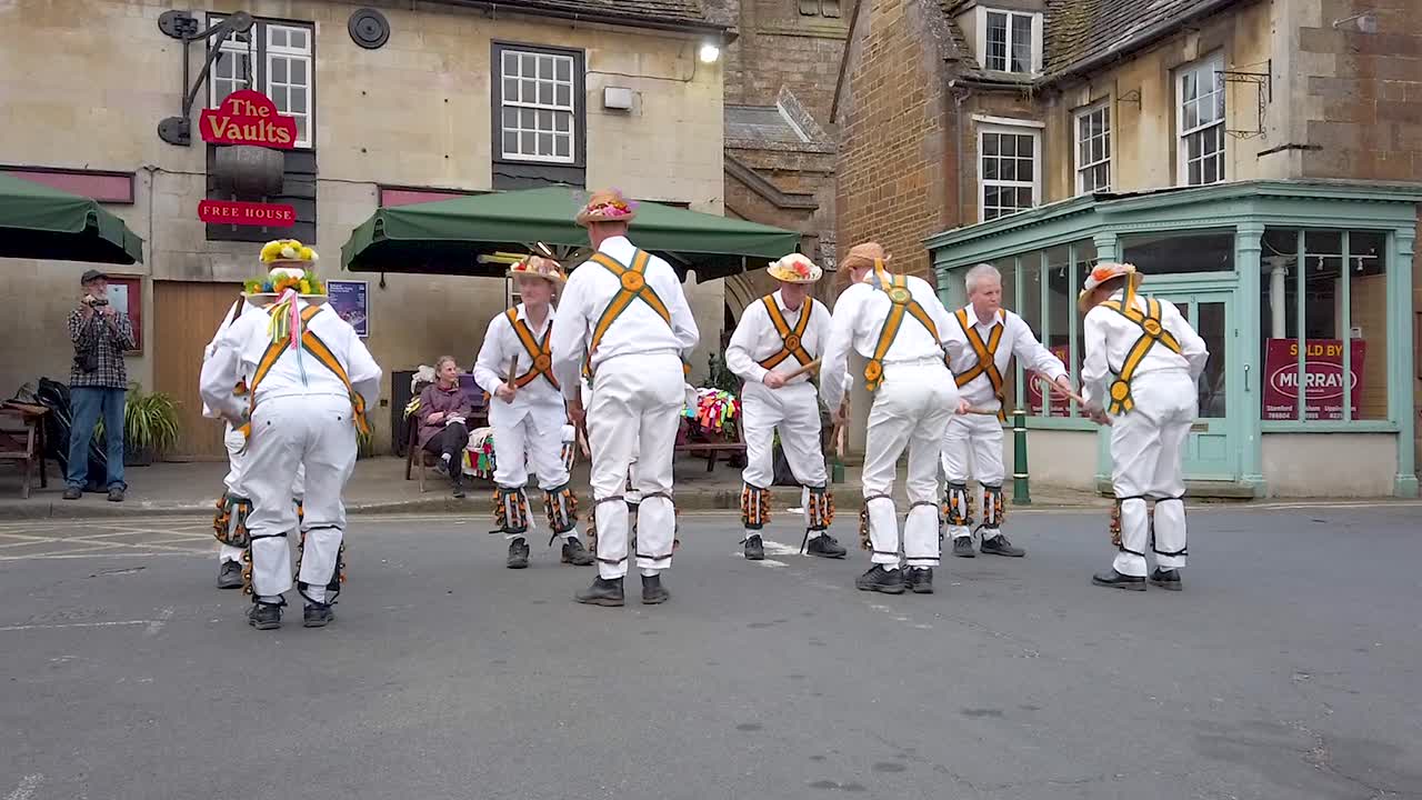 Rutland Morris Men performing in Uppingham market place of music and folk dancing with a range of traditional folk dancing