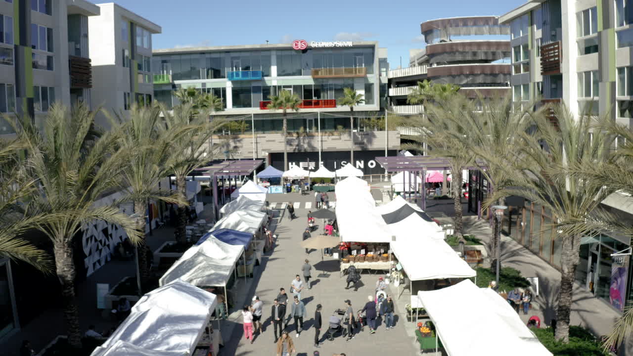 Bustling Outdoor Market with Shoppers and Stalls