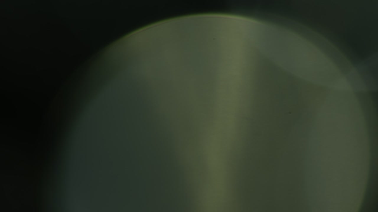 Multicolored light leaks 4k footage on black background. Stylizing video, transitions. Bokeh effect