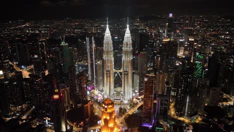 Aerial-nighttime-pull-out-shot-of-the-Petronas-Tower-in-the-city-of-Kuala-Lumpur