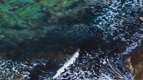 Dirty-sea-pattern-with-algae-under-water-waving-and-foaming-on-sandy-beach-in-Mediterranean-coastline