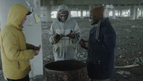 homeless individuals finding warmth and community under a bridge
