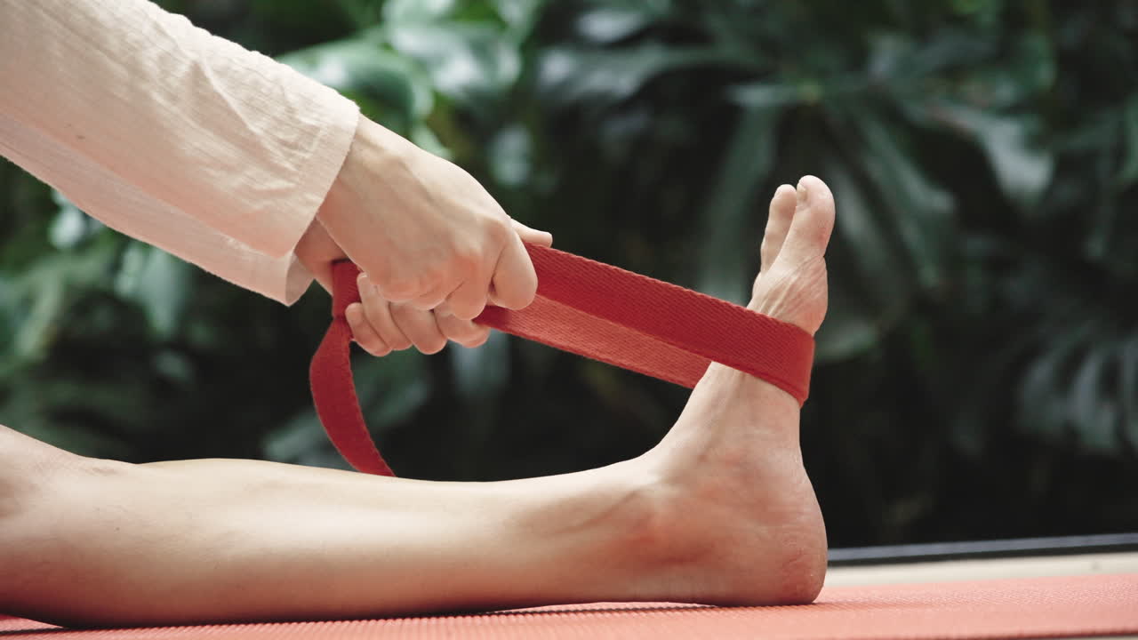 Close-Up of Person Stretching Foot with Yoga Strap
