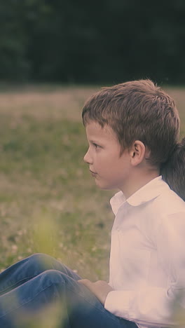 tired schoolboy in shirt throws away textbook leaning on sleeping boy holding workbook near face close view slow motion