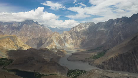 drone shot passing two hikers on top a mountain cliff, kakshaal too mountain range in kyrgyzstan