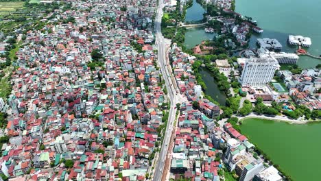 Cinematic-closeup-shot-of-the-colorful-houses-in-Hanoi,-Vietnam-following-a-main-street-shot-on-a-Mavic-3-Classic-in-4K-on-a-sunny-day-in-July,-Drone