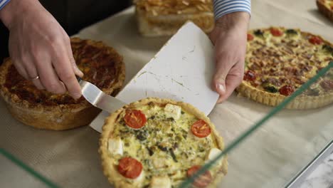 Close-up-male-hands-putting-pie-on-the-counter-in-bakery-store