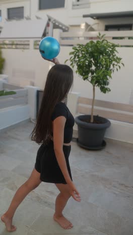 woman exercising with a ball outdoors