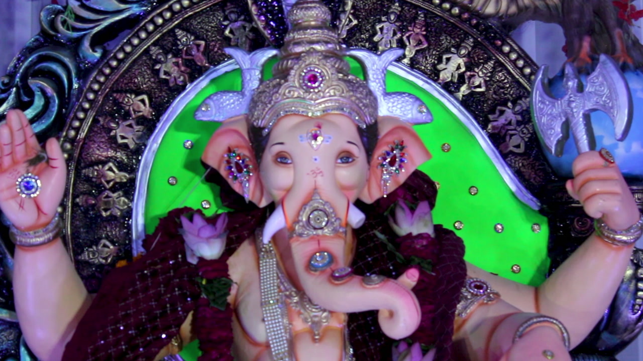 Beautiful Ganpati idol in decorated pandal with colorful lights for Ganesh Chaturthi. Perfect footage for Indian festival, culture, spirituality, devotion and celebration.
