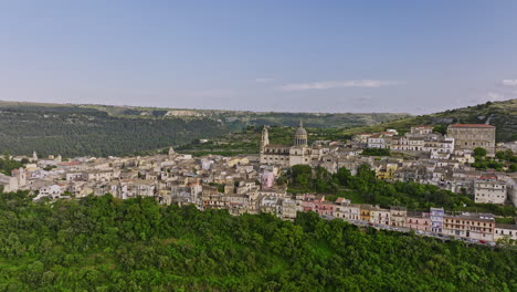 ragusa italy aerial v1 reverse flyover the valley capturing picturesque landscape of ragusa ibla with charming church and historic town nestled on the hillside - shot with mavic 3 cine - june 2023