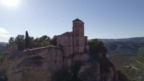 montefrio. village church. iglesia de la villa. church next to cliff. aerial view of andalusian town and church on cliff. montefrio. andalusia. spain.