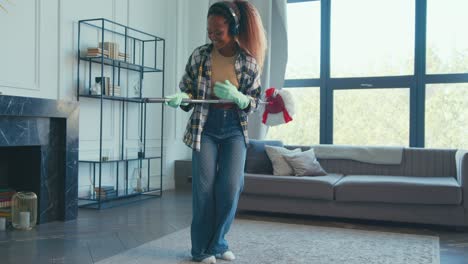 dancing while cleaning in a bright living room during a sunny afternoon