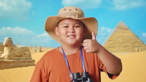 happy boy explorer in front of pyramids