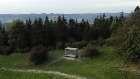 aerial pan of viewpoint structure and hilly green forest in czech rep