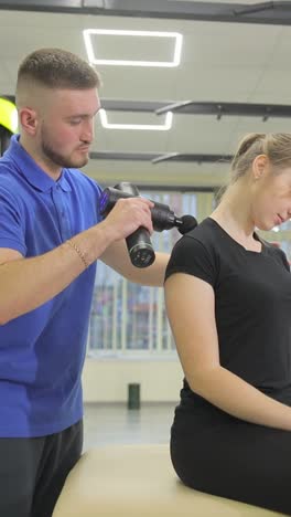 restorative therapy and massage gun stimulation in the fitness room restorative therapy and massage gun stimulation in the fitness room