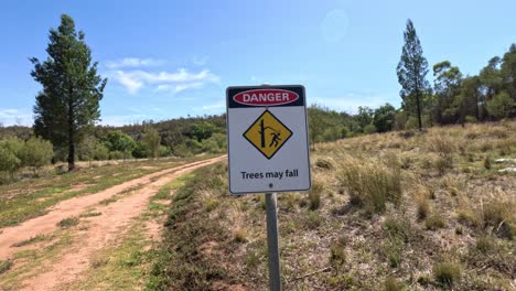 sign warns of falling trees ahead