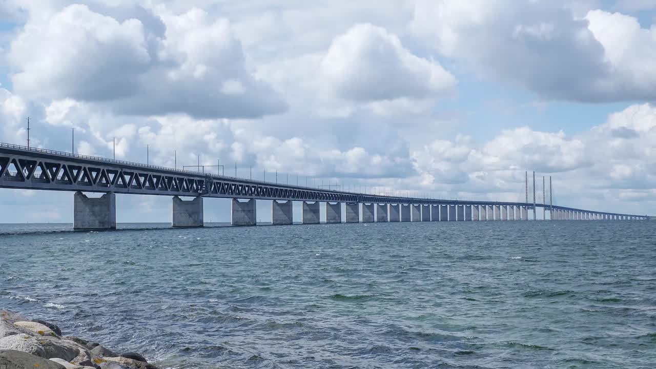Timelapse Oresundsbron with blue sky and white clouds.