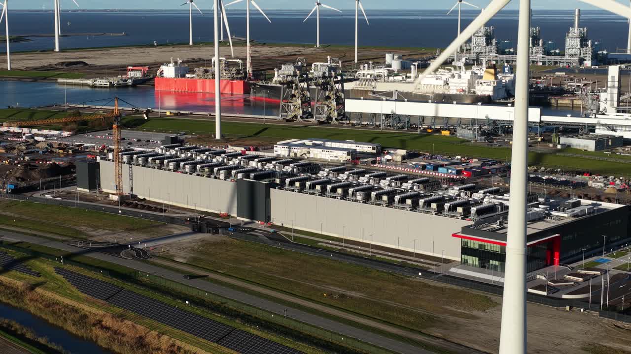 Aerial drone video showing the massive IT expansion in Eemshaven, Groningen, with existing and new hyperscale data center buildings, highlighting digital infrastructure and growth