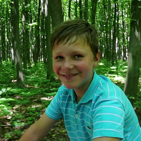 boy biking on forest trails slow motion