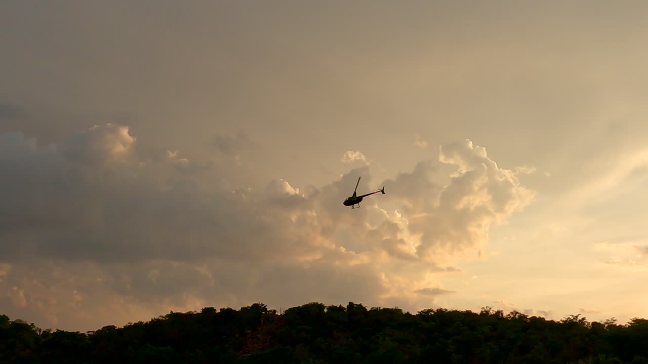Chopper flying at dawn over African nature reserve on conservation project