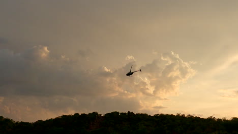 helicóptero volando al amanecer sobre la reserva natural africana en un proyecto de conservación