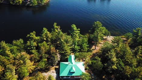 gorgeous 4k aerial shot of lake with island cottages on a beautiful sunny day