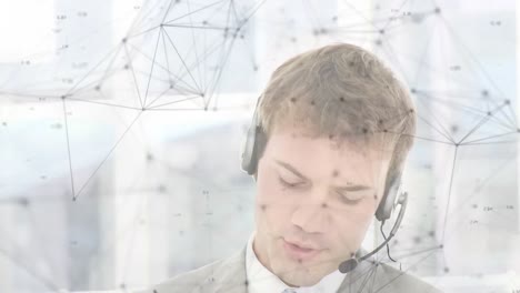 Animation-of-network-of-connections-over-businessman-with-headset-in-office