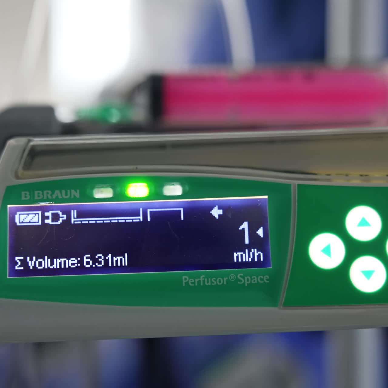 Switched on device with lit buttons. Close up. Modern infusor equipment in surgery room