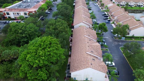 crane up drone shot of west palm beach residential area and real estate with a lake during the day in florida, usa