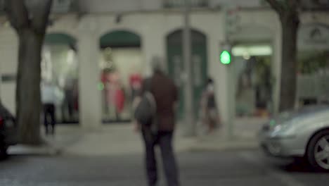 man zebra crossing with green traffic light, out of focus camera, in slow motion