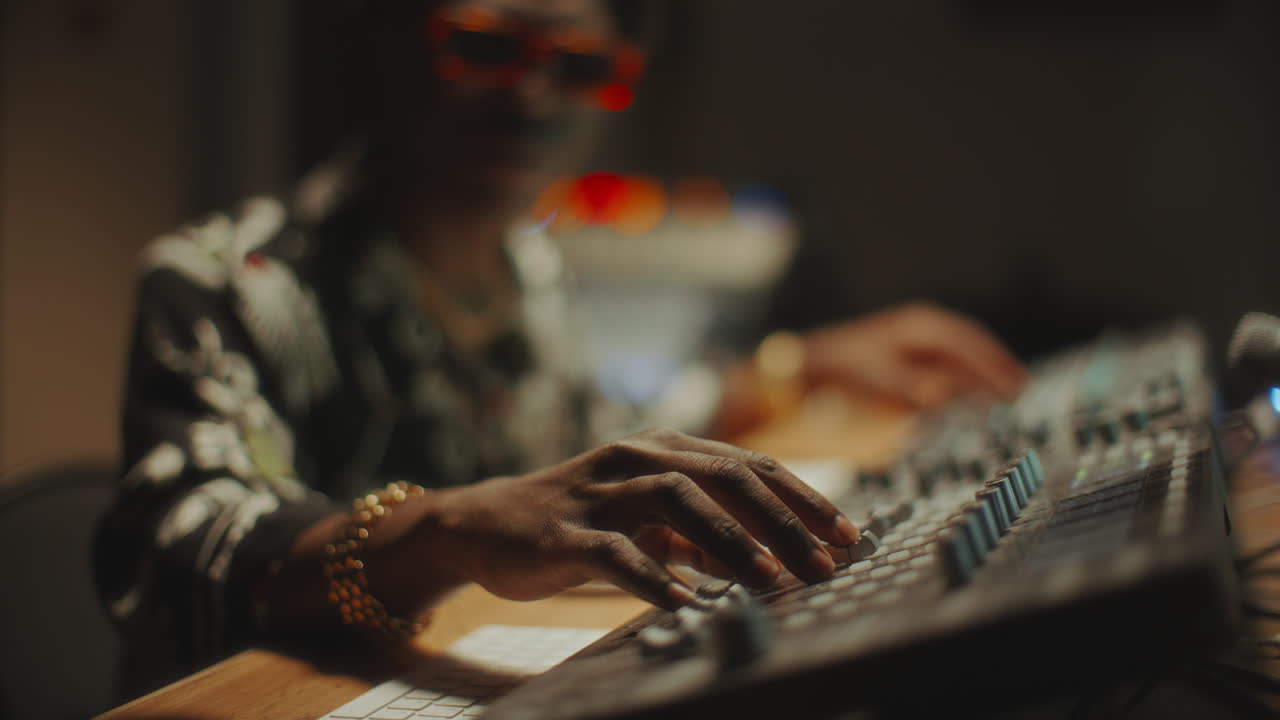 Close-Up of Music Producer Adjusting Knobs Audio Mixer in Recording Studio