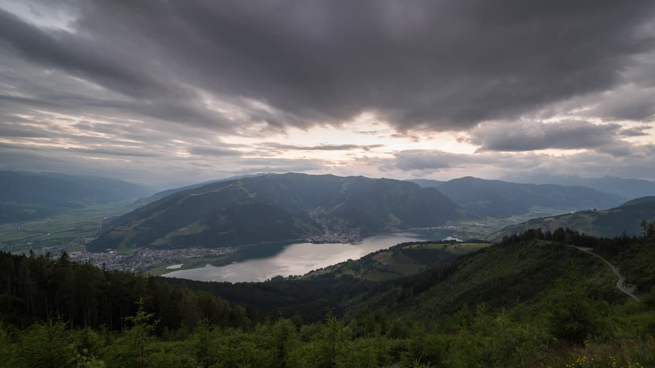 Timelapse of a view above Zell am See Kaprun, Austria. Cloud passing and day turning into night
