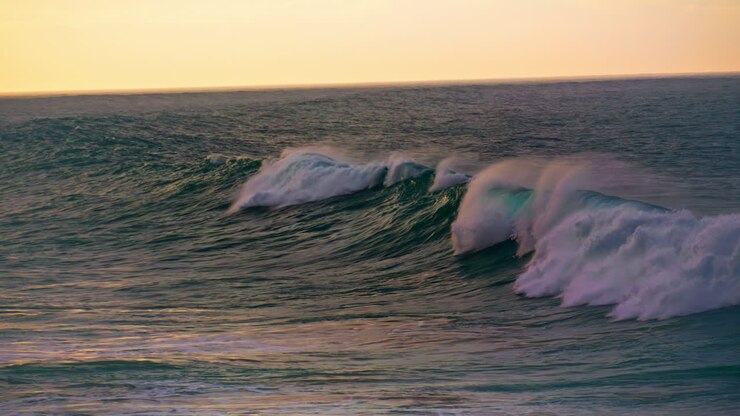 Stormy ocean water rolling in super slow motion. Foamy waves breaking surface