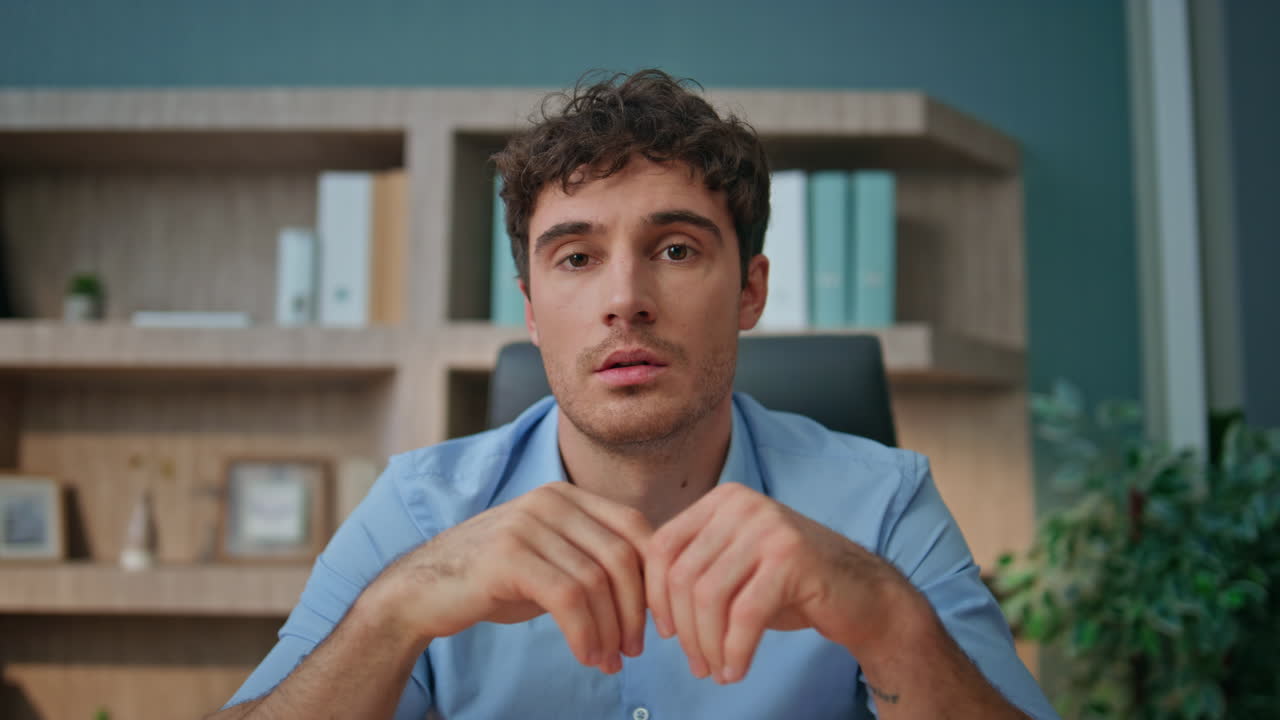 Man speaking interview call at home office closeup. Pensive employee consulting