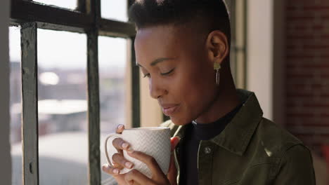 beautiful woman drinking coffee at home enjoying aroma looking out window relaxing happy african american female smiling satisfaction close up