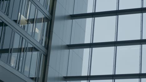 modern glass office building with reflective windows and clean lines