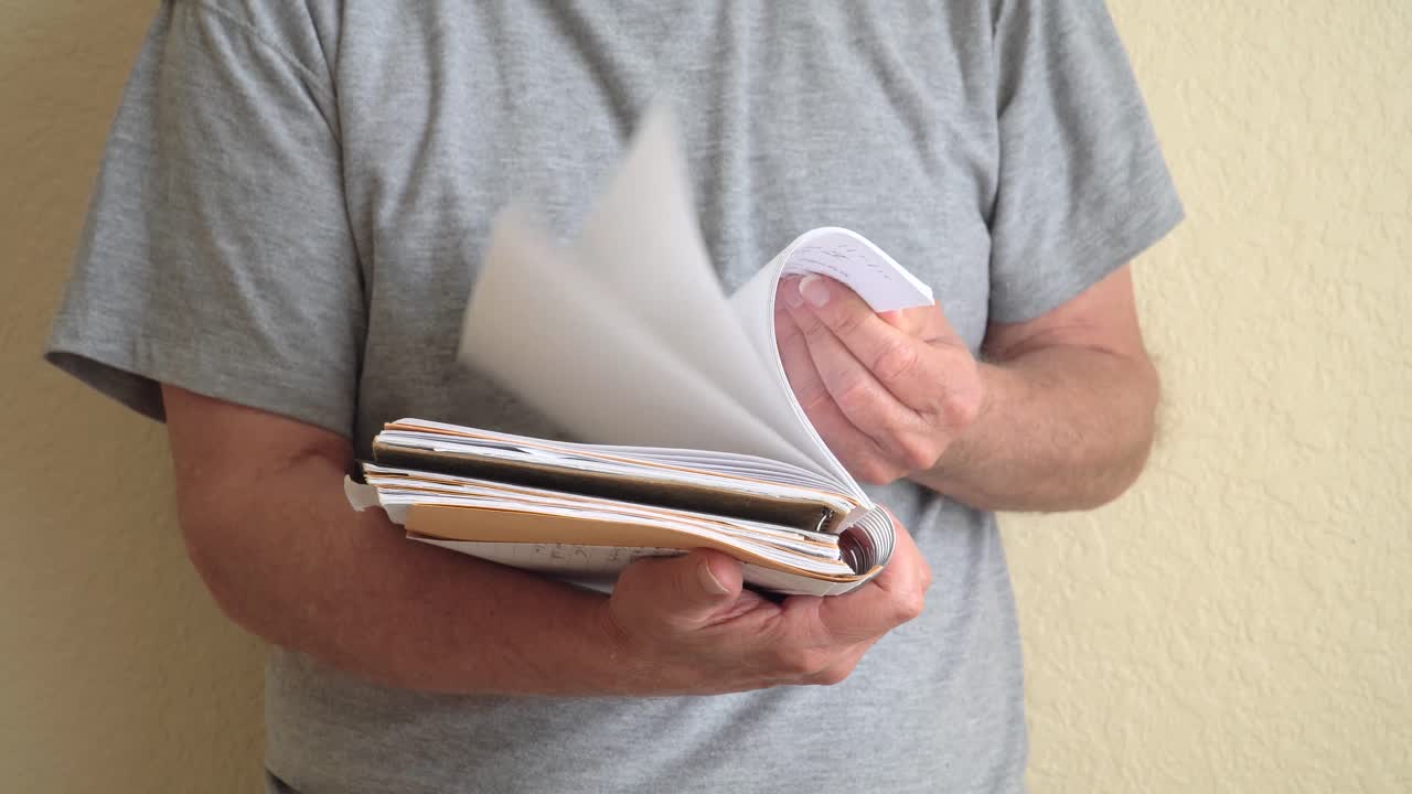 Person flipping through pages of a note book