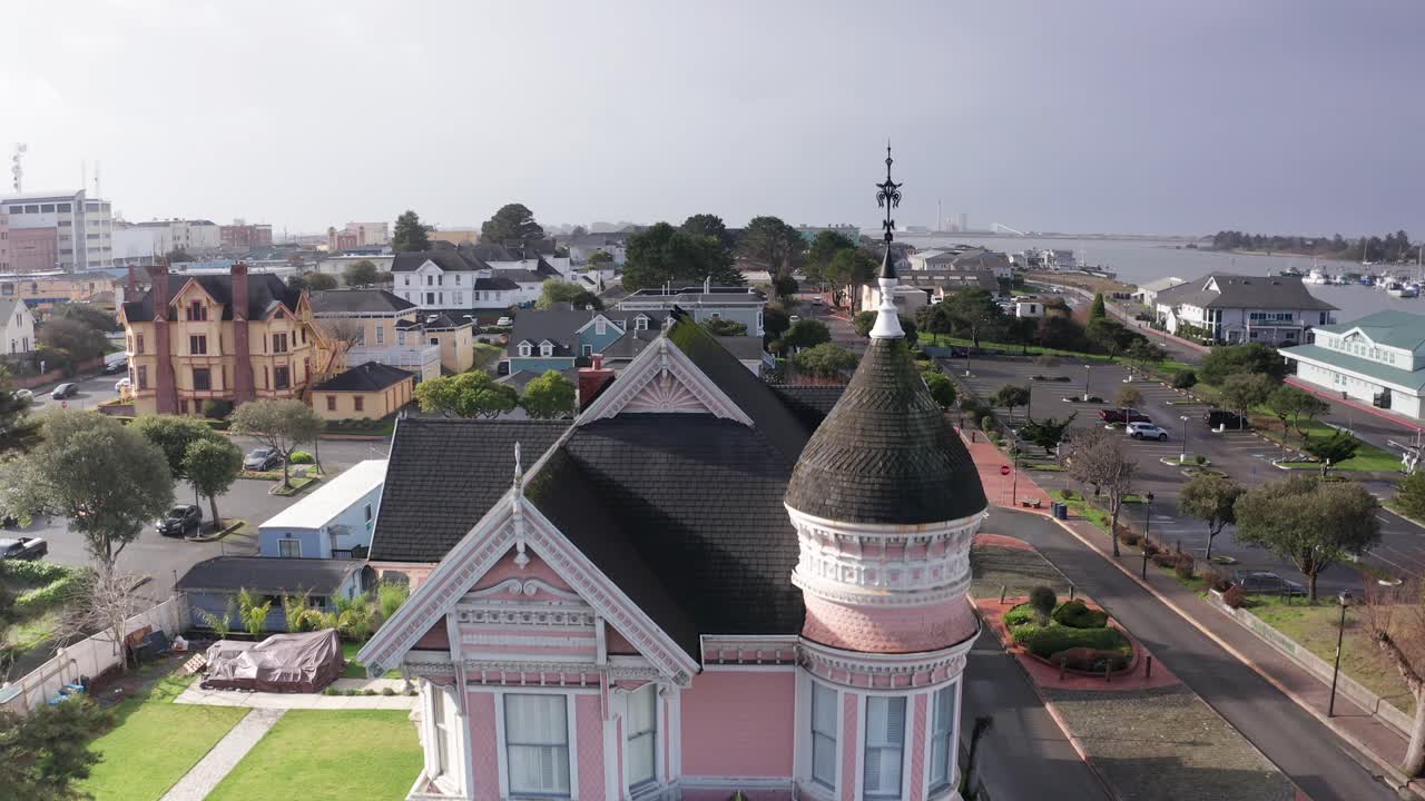 Aerial rising close-up shot of the quaint Pinc Lady Mansion, a historic Victorian home in Eureka, California. 4K