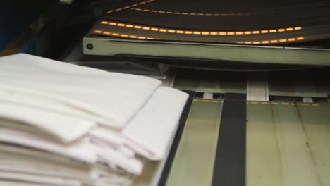 folded sheets loaded on conveyor belt