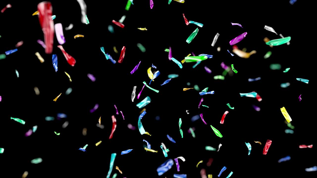 Confetti blasted upward falls slowly against a solid background.