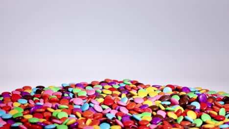 vibrant candies cascade into a growing pile