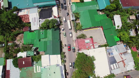 dynamic overhead of a busy city street with trucks driving and tourists shopping in downtown puerto viejo, a popular travel destination and important port town on the caribbean coast of costa rica.