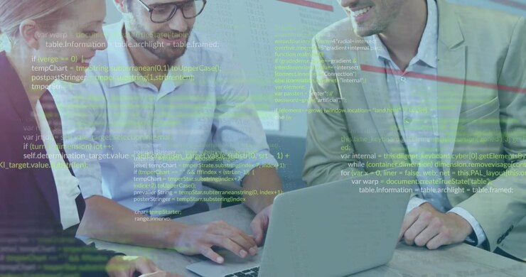 Three professionals leaning over laptop with code overlay appearing and guiding tech project review